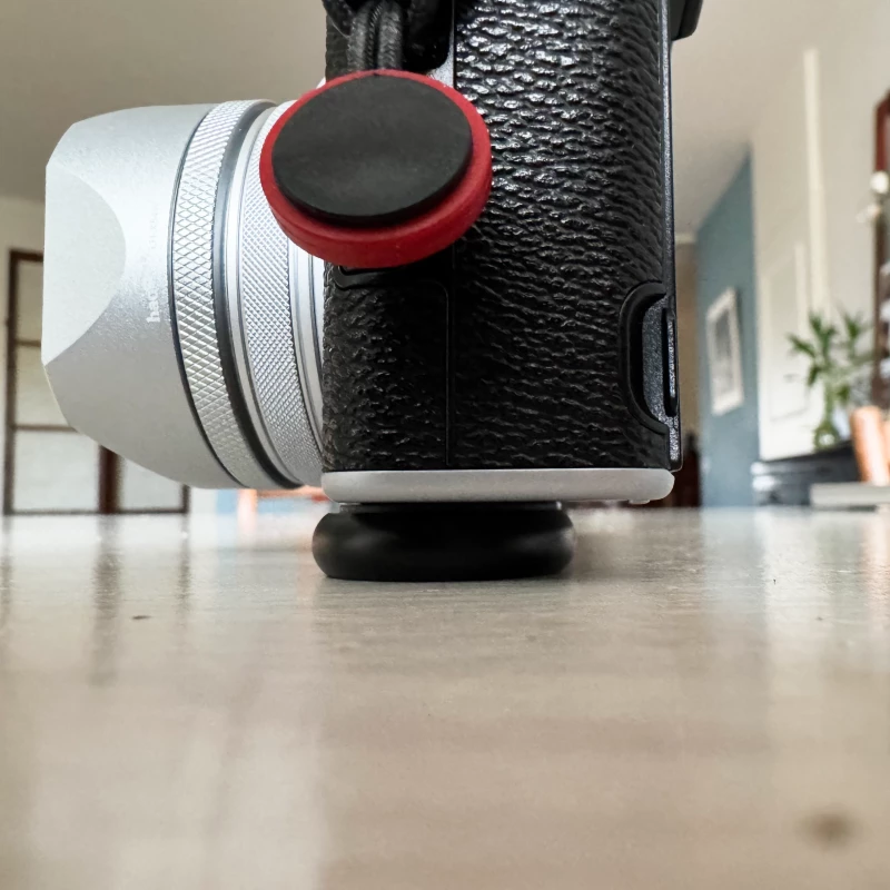 Fujifilm X100VI side view mounted with Peak Design's Micro Clutch overlapping in front